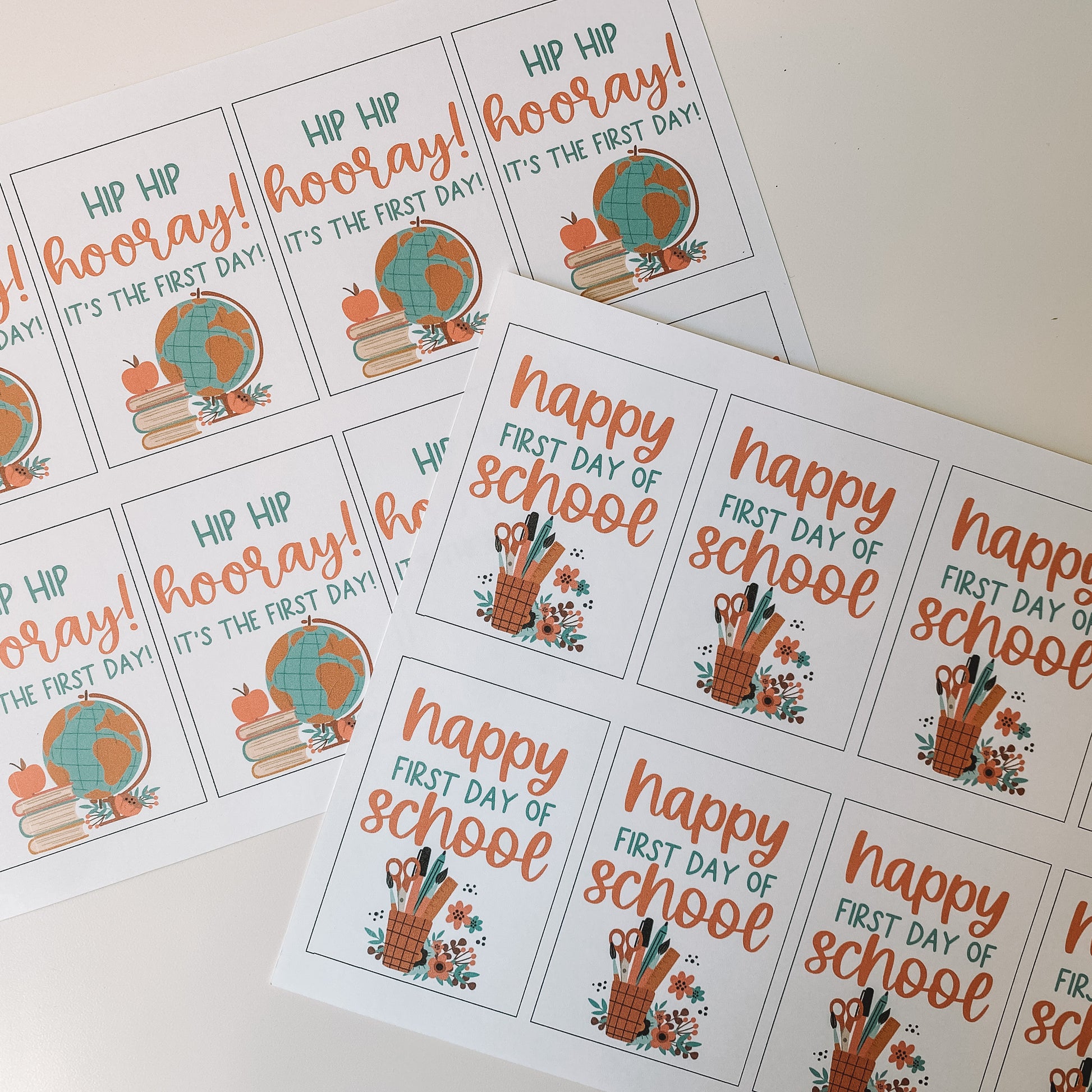 Hip hip hooray it is the first day and happy first day of school gift tags displayed on an 8.5 by 11 inch paper before cutting. There are eight of each tag printed on each page.