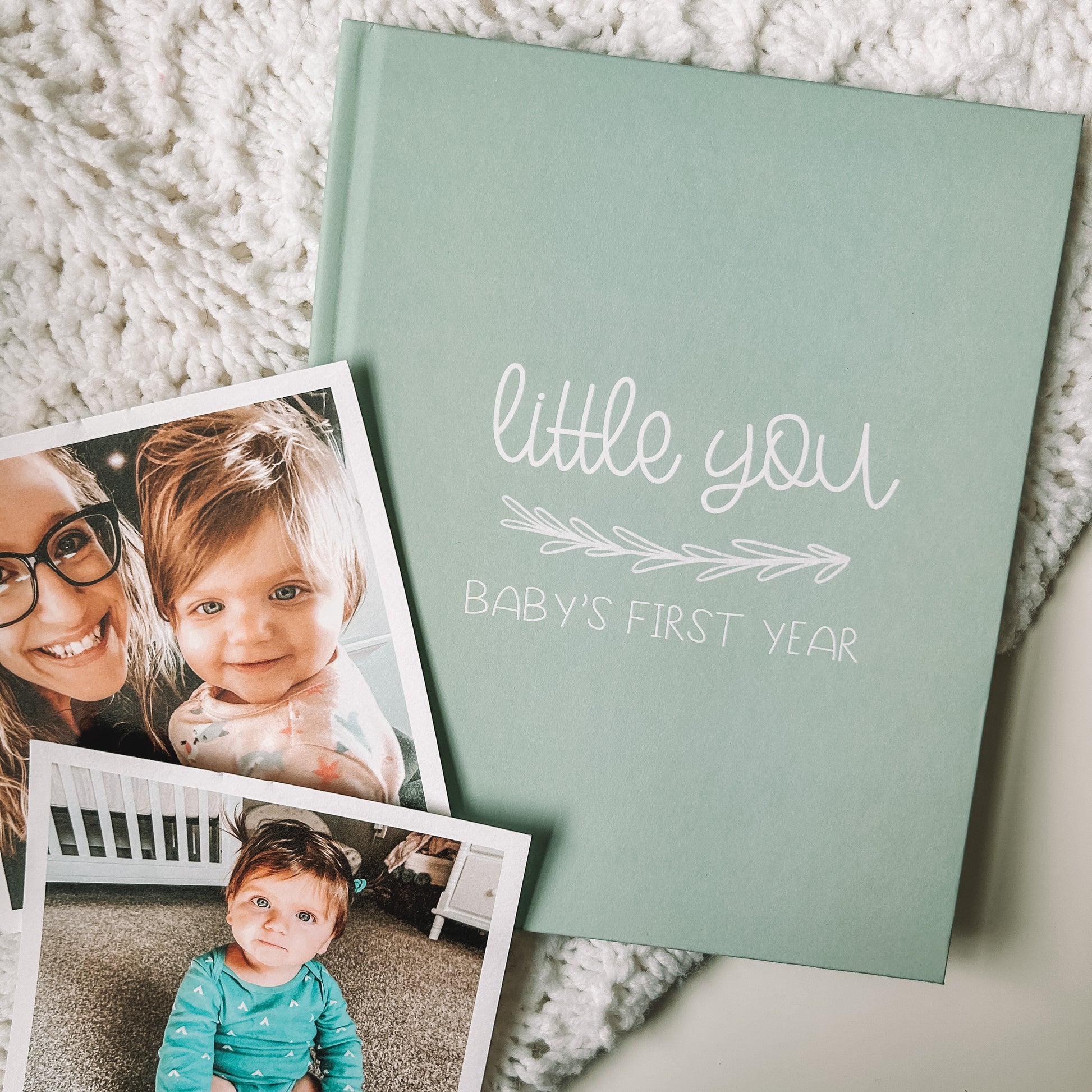 Keepsake baby book with a green cover titled Little You Baby's First Year in white text.