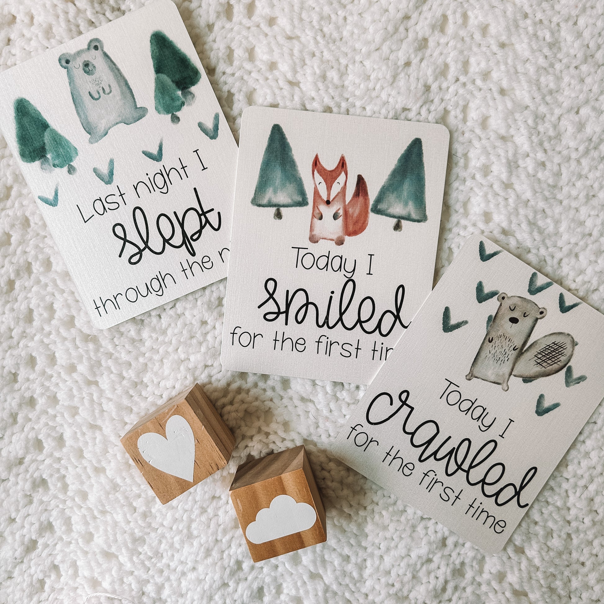 last night I slept through the night, today I smiled for the first time, and today I crawled for the first time milestone cards. Woodland animals and trees or hearts above the text