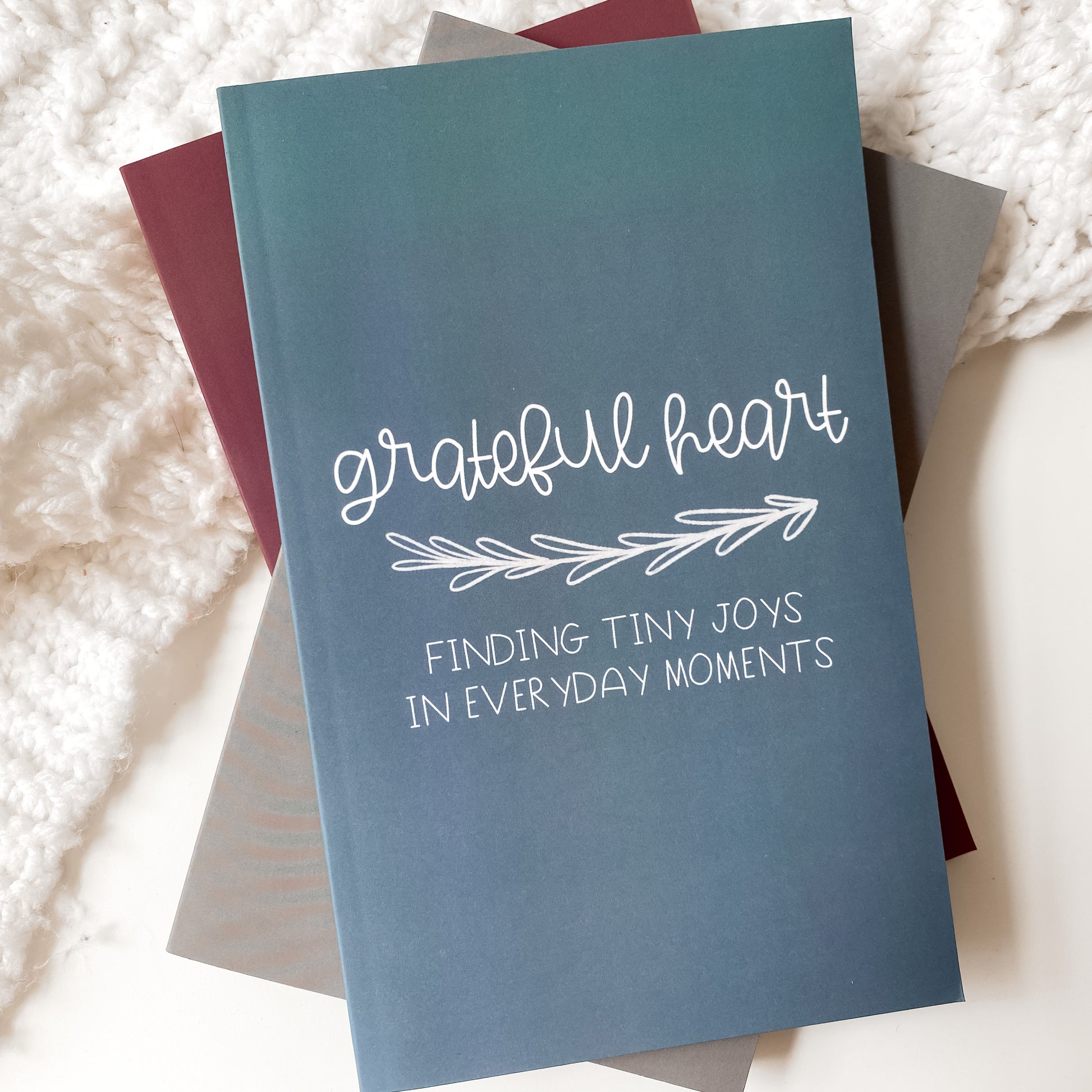 Blue gratitude journal titled Grateful Heart Finding Tiny Joys in Everyday Moments