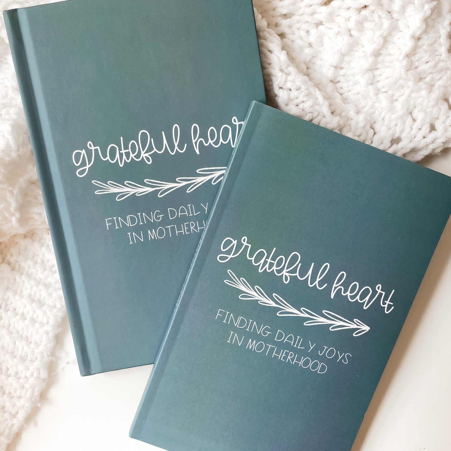 Blue gratitude journals in hardcover and paperback titled Grateful Heart Finding Daily Joys in Motherhood
