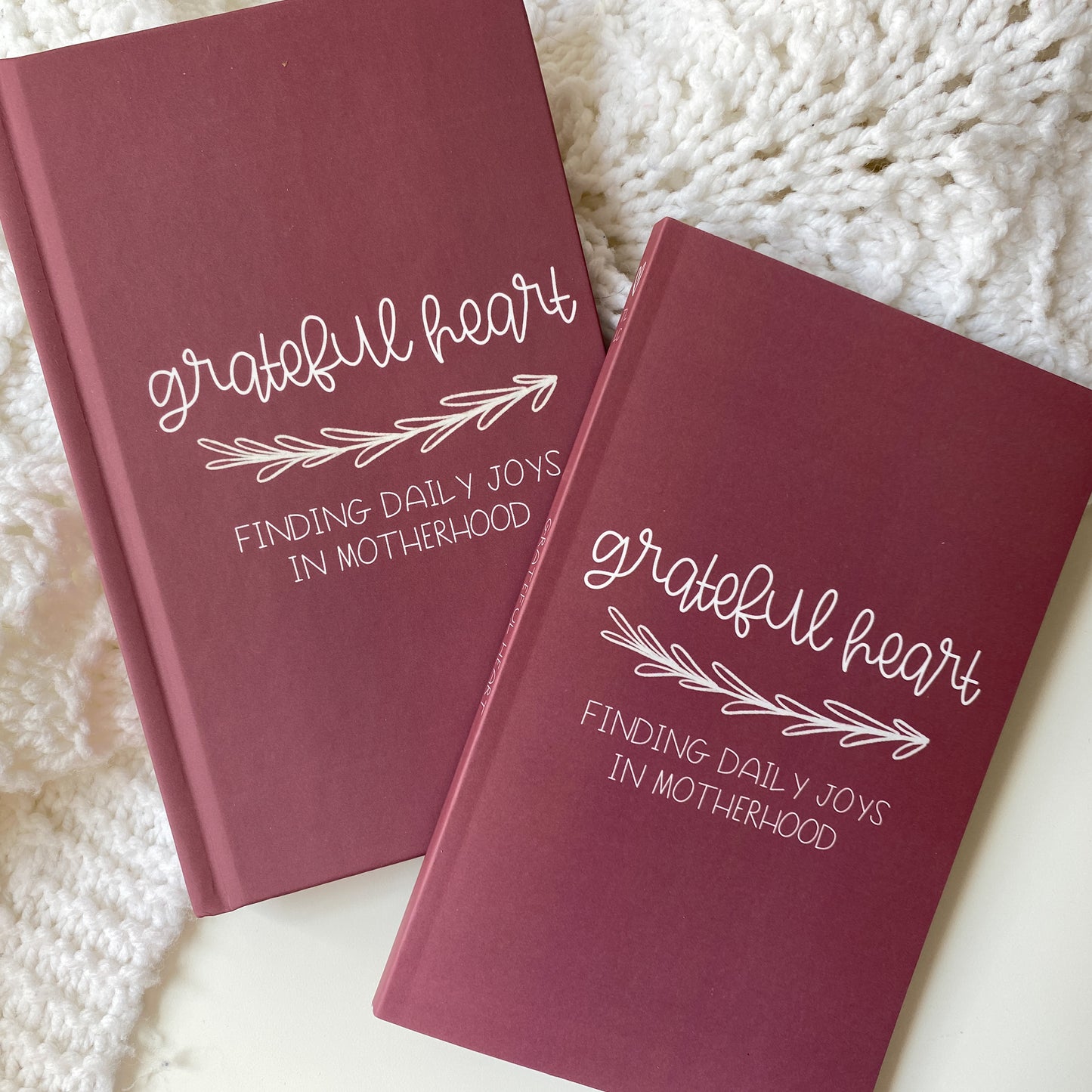 Maroon gratitude journals in hardcover and paperback titled Grateful Heart Finding Daily Joys in Motherhood