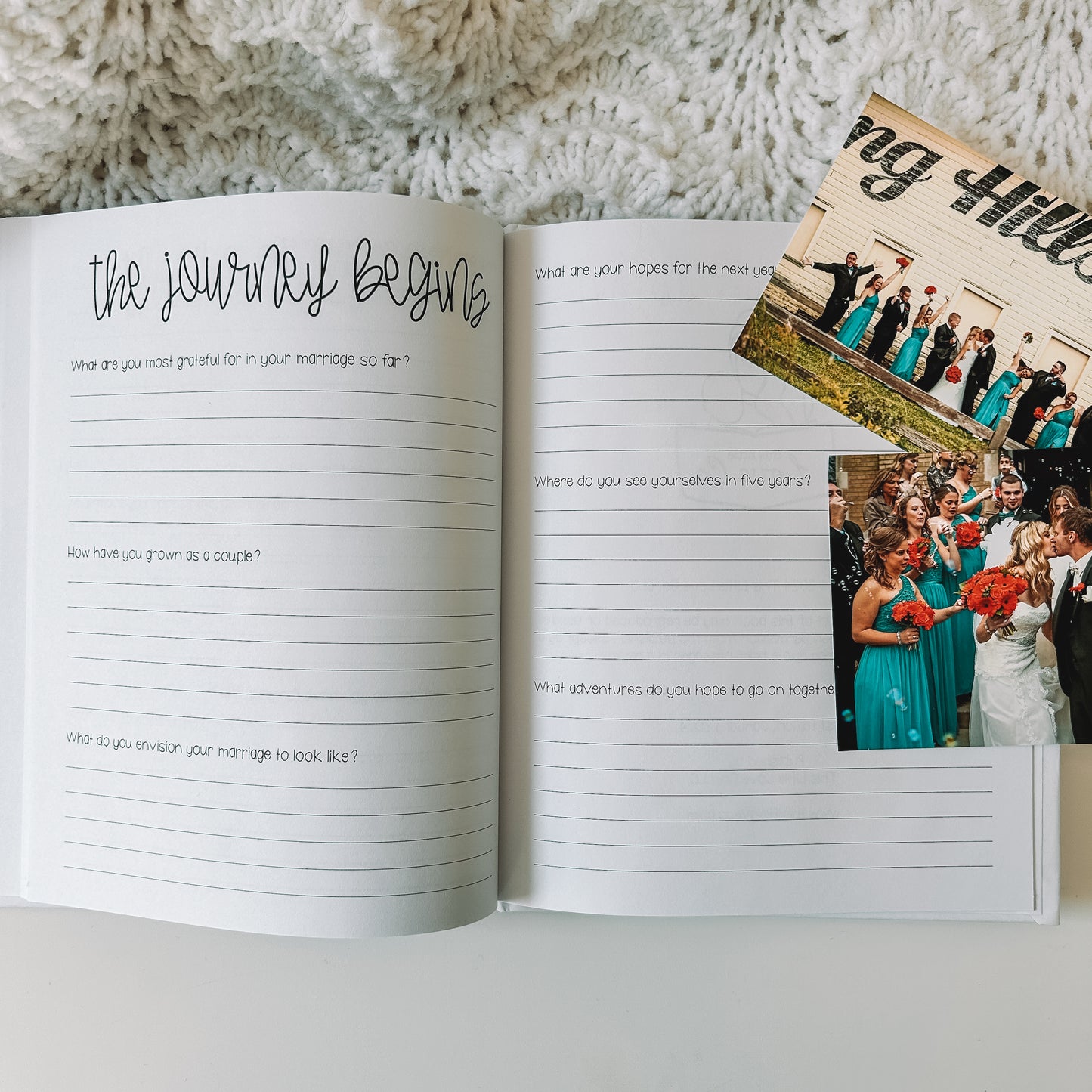 Two page spread in prompted engagement journal. Left page is titled the journey begins with prompts and blank lines beneath each prompt. Right page has only prompts with blank lines beneath each prompt. Wedding photos lie next to the book.