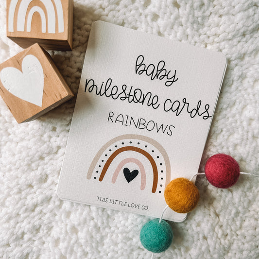 cover card that reads baby milestone cards rainbows with an image of a rainbow below. This Little Love Co is in small text at the bottom of the card