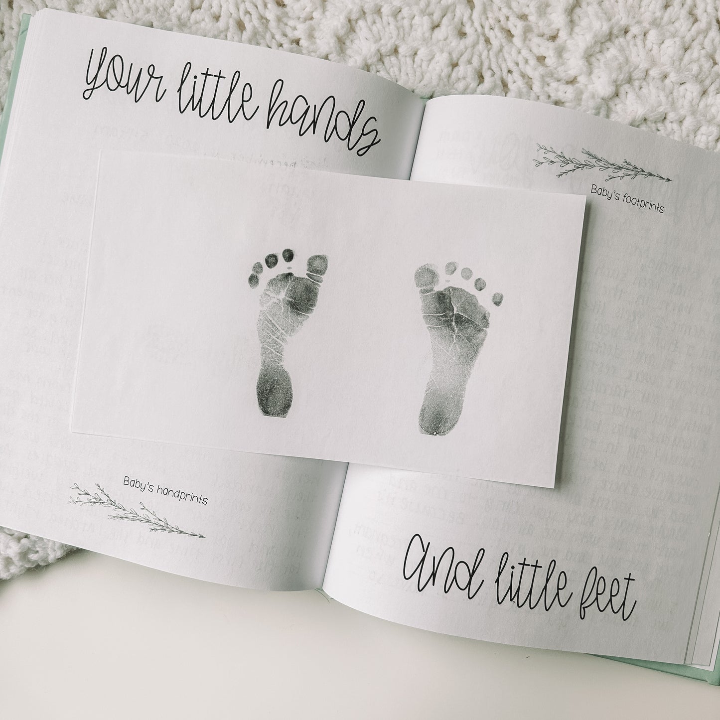 Two page spread titled your little hands and little feet with a sheet with baby footprints stamped.
