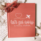 Keepsake travel journal with a soft, matte coral hardcover. White text reads Lets Get Away A Travel Journal with a graphic of a white airplane leaving a heart trail behind it.
